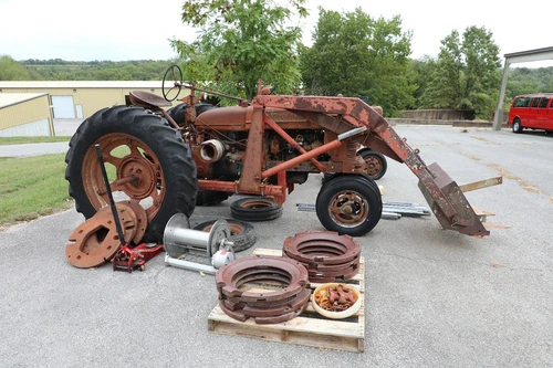 Vintage tractor and parts located at the transportation parking lot